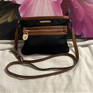 Black Crossbody Nylon Michael Kors. brown leather strap in perfect condition.